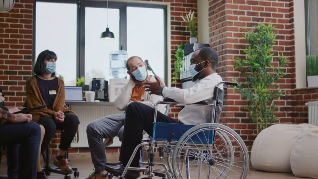 man with disability attending group therapy. 