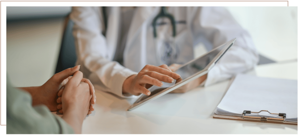 Close-up of a medical professional reviewing information with a claimant