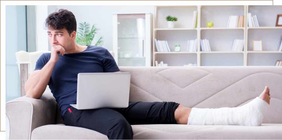 A person with an injury sitting on a couch