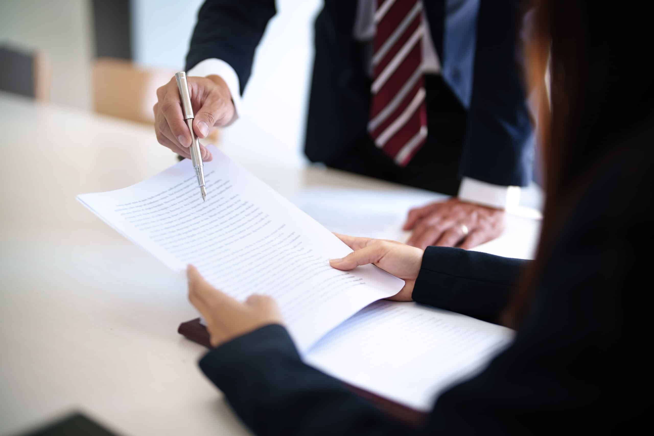 Lawyer with lawsuit meeting with client discussing with contract agreement at courtroom.