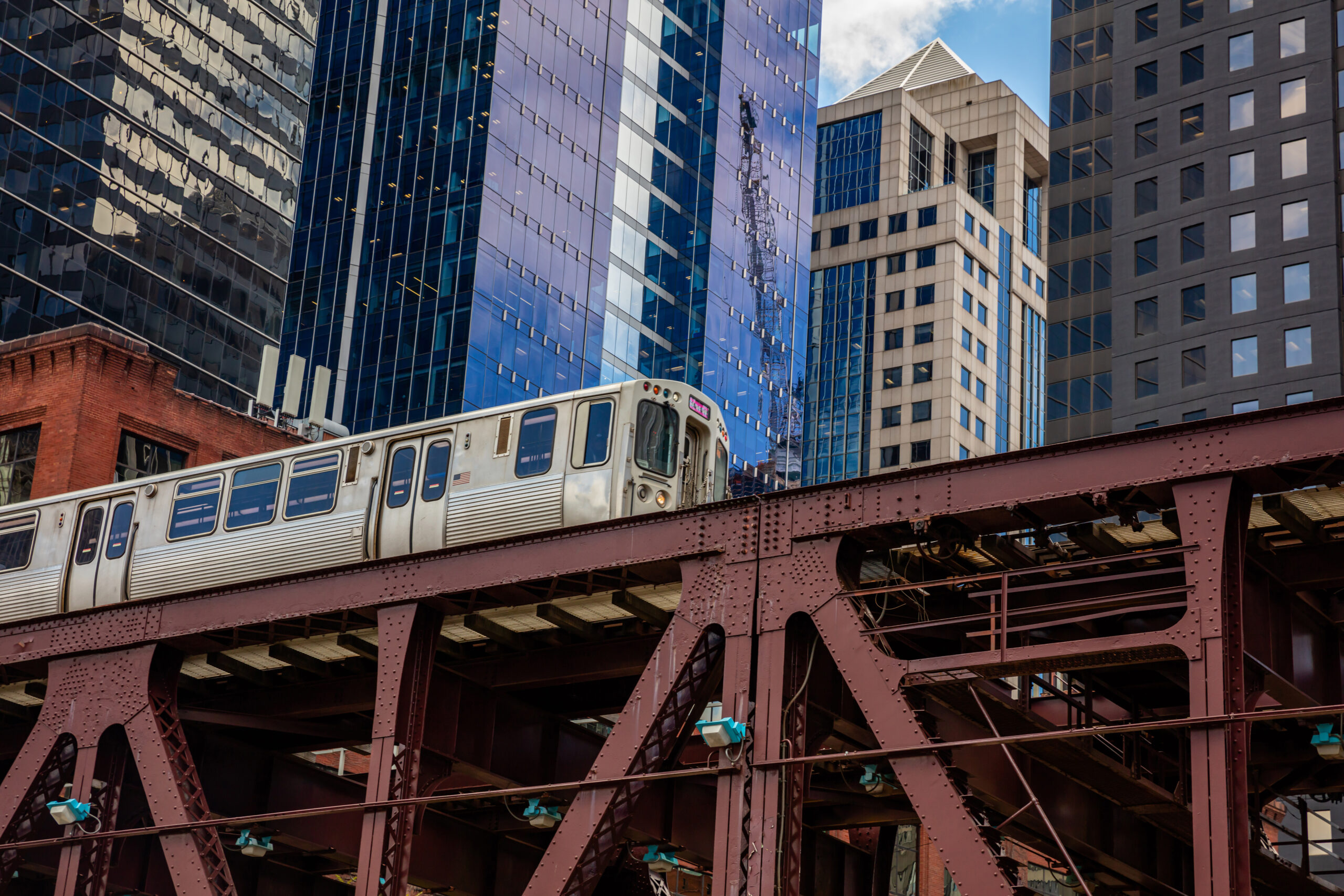 Chicago train on a bridge, skyscrapers background, low angle view