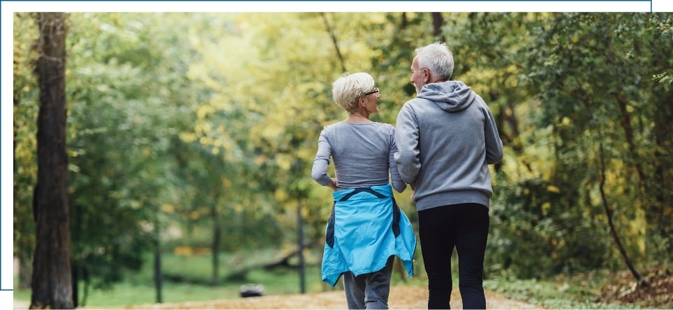 an older couple walking together discussing their disability policy and narcolepsy