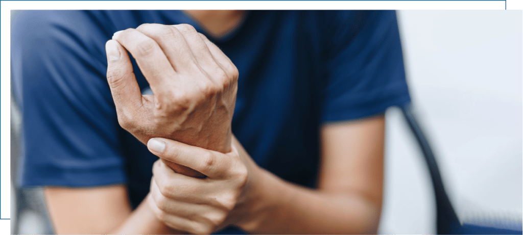 A close-up of one hand holding the other wrist