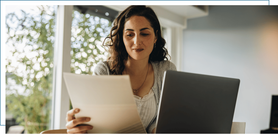 a woman reviewing documents for an essential tremor disability claim