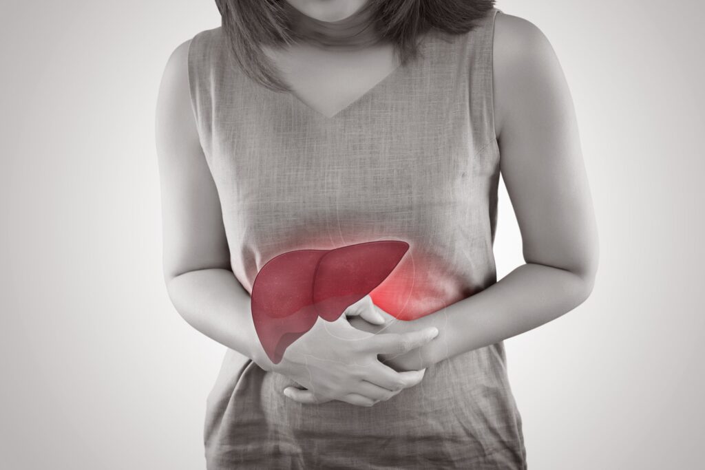 Woman clutching abdomen with illustrated liver overlay highlighting pain and inflammation in the upper right quadrant