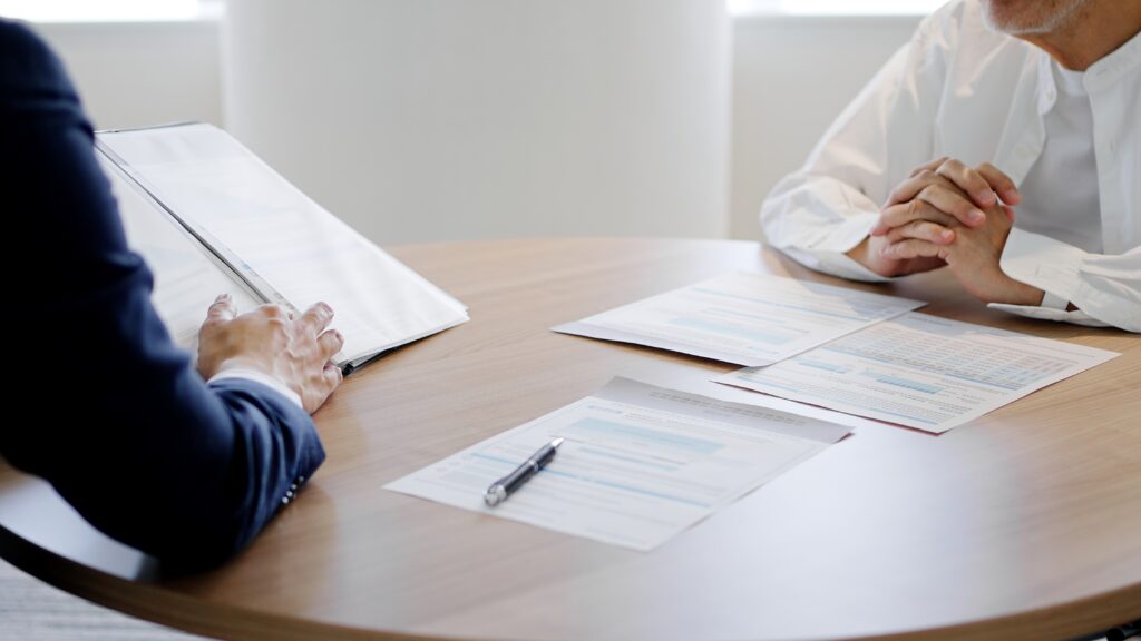 Disability attorney reviewing ERISA claim documents with a client across a desk