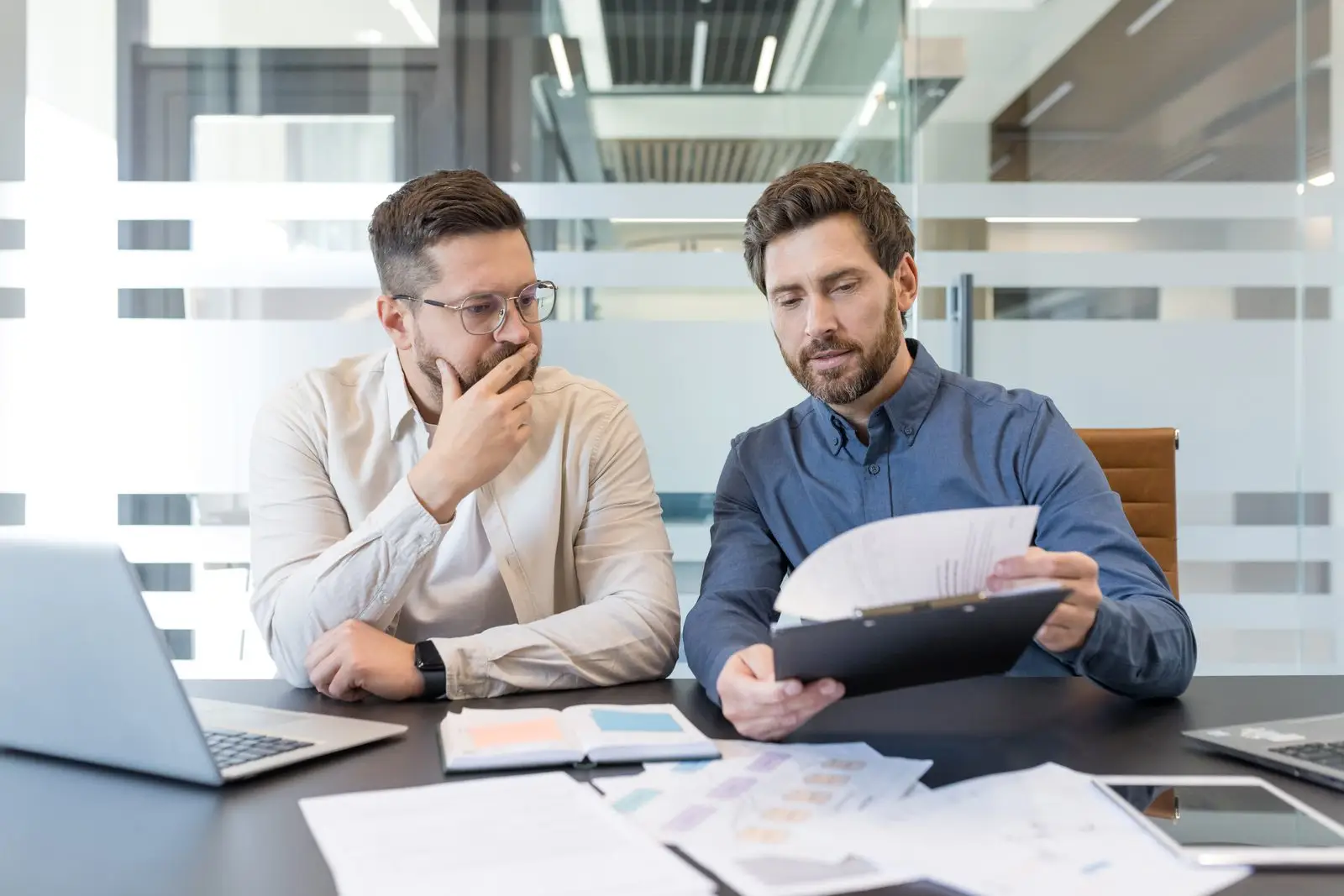 Long-term disability attorney reviewing a claim denial letter with a client
